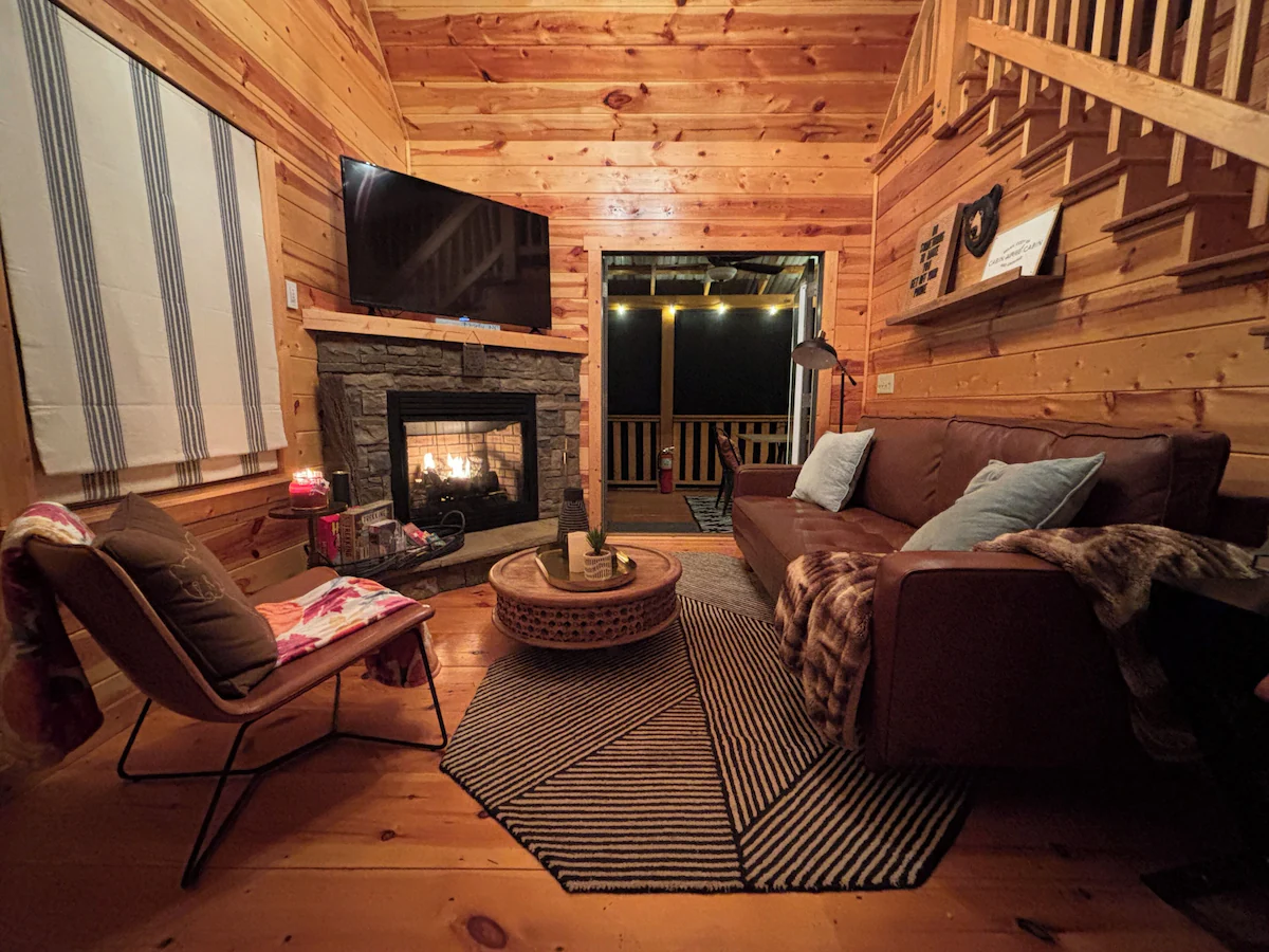 Great room with fireplace in a Murphy NC cabin rental at The Cozy Nook