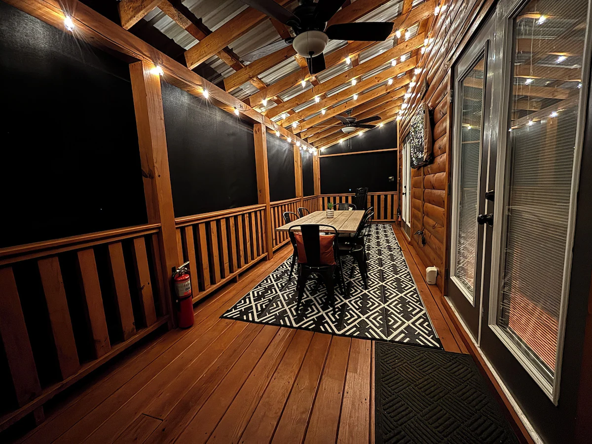 Screened porch seating at The Cozy Nook