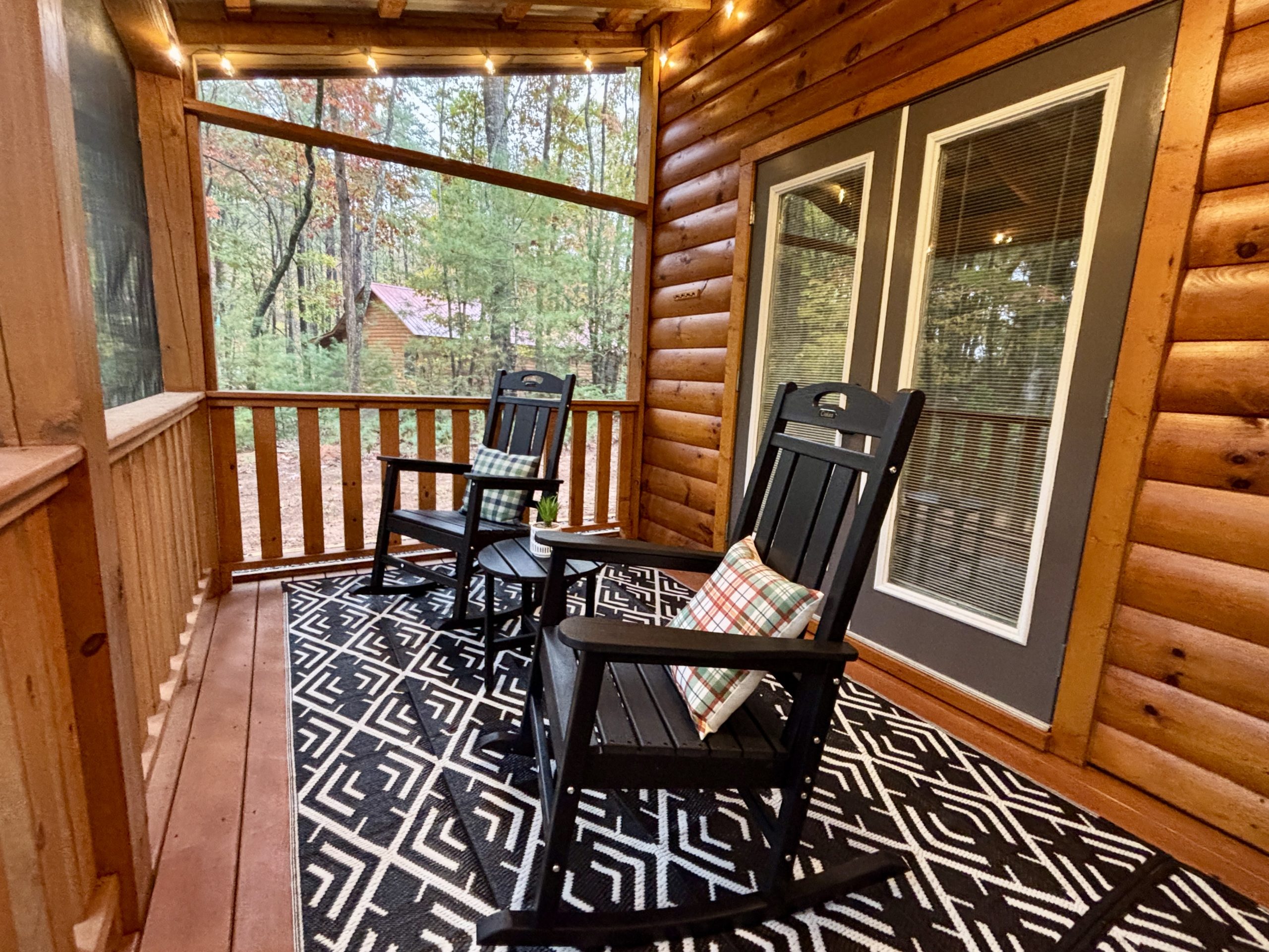 Rocking chairs on the screened porch during the day at The Cozy Nook