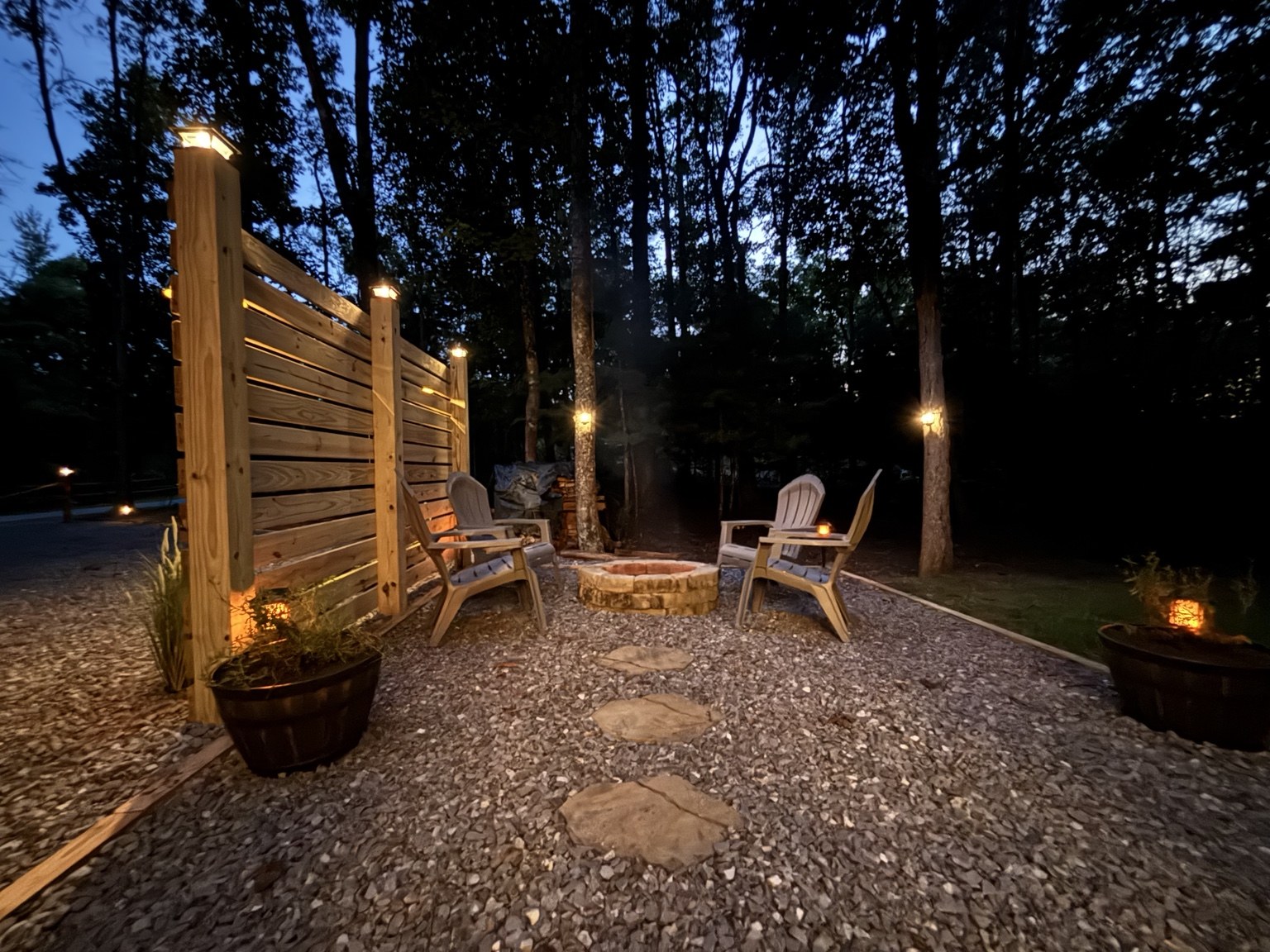Illuminated private fire pit area at The Cozy Nook after sunset