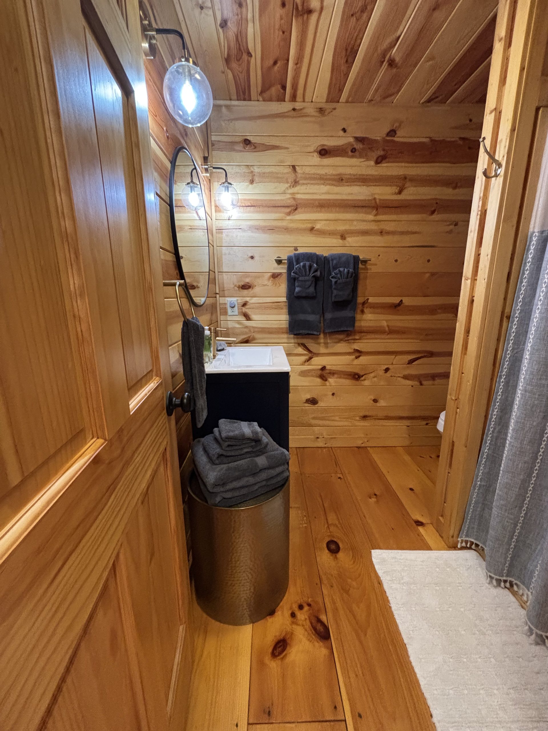 Full bathroom with vanity and fresh towels at The Cozy Nook cabin