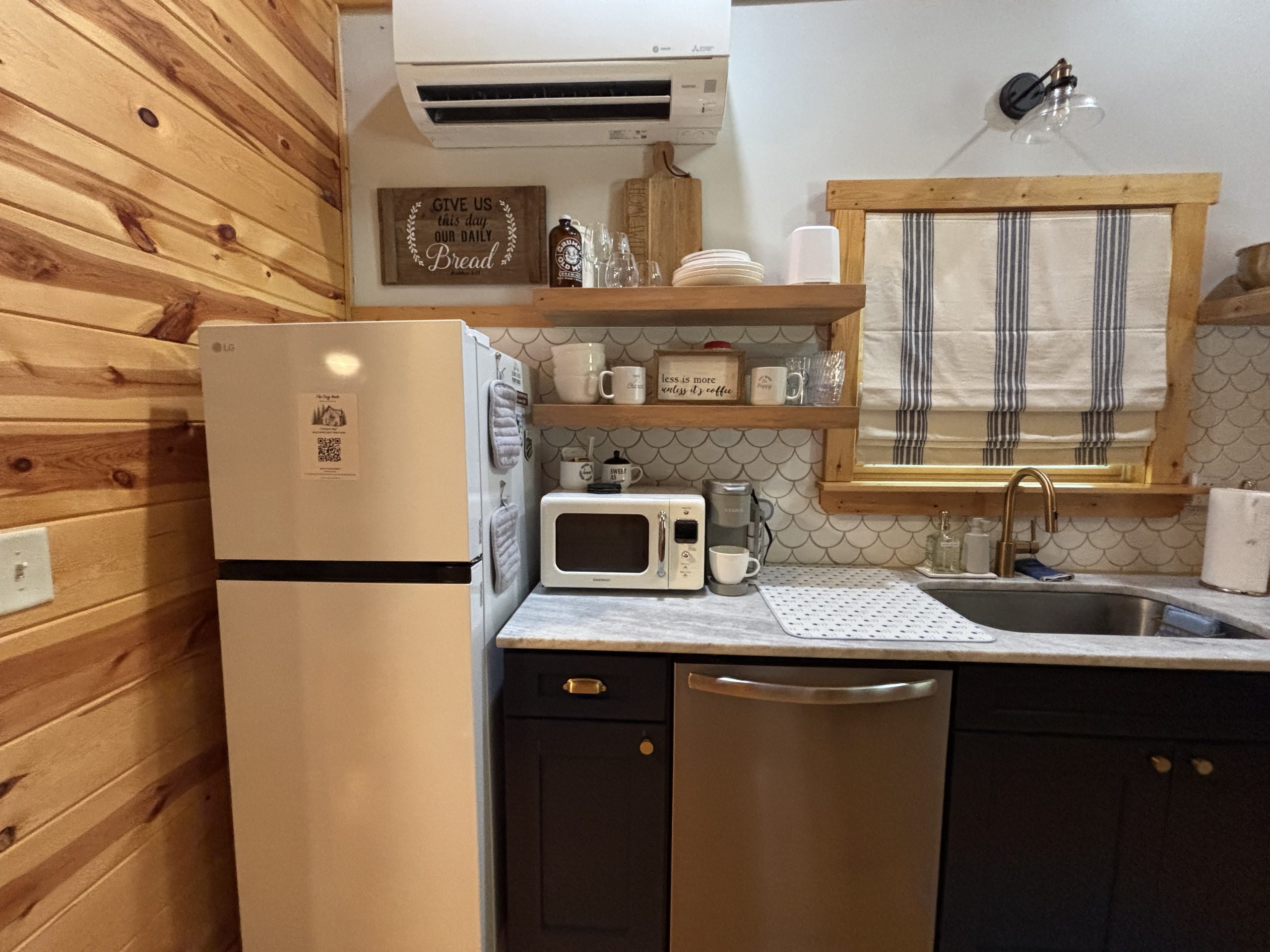 Updated fully equipped kitchen with refrigerator, dishwasher, microwave and sink at The Cozy Nook