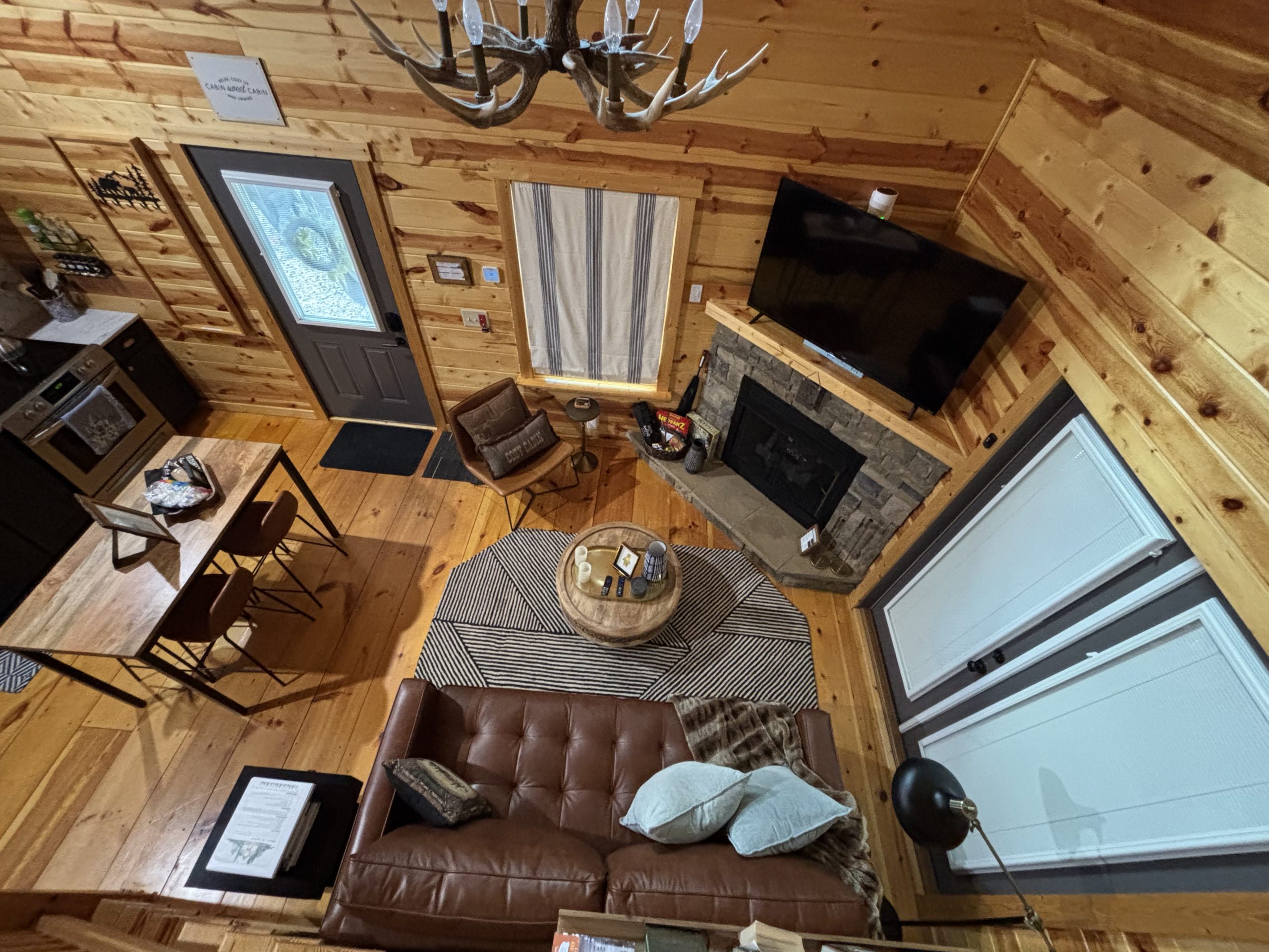 Overhead view of the living room, fireplace, dining area and kitchen at The Cozy Nook cabin in Murphy, North Carolina