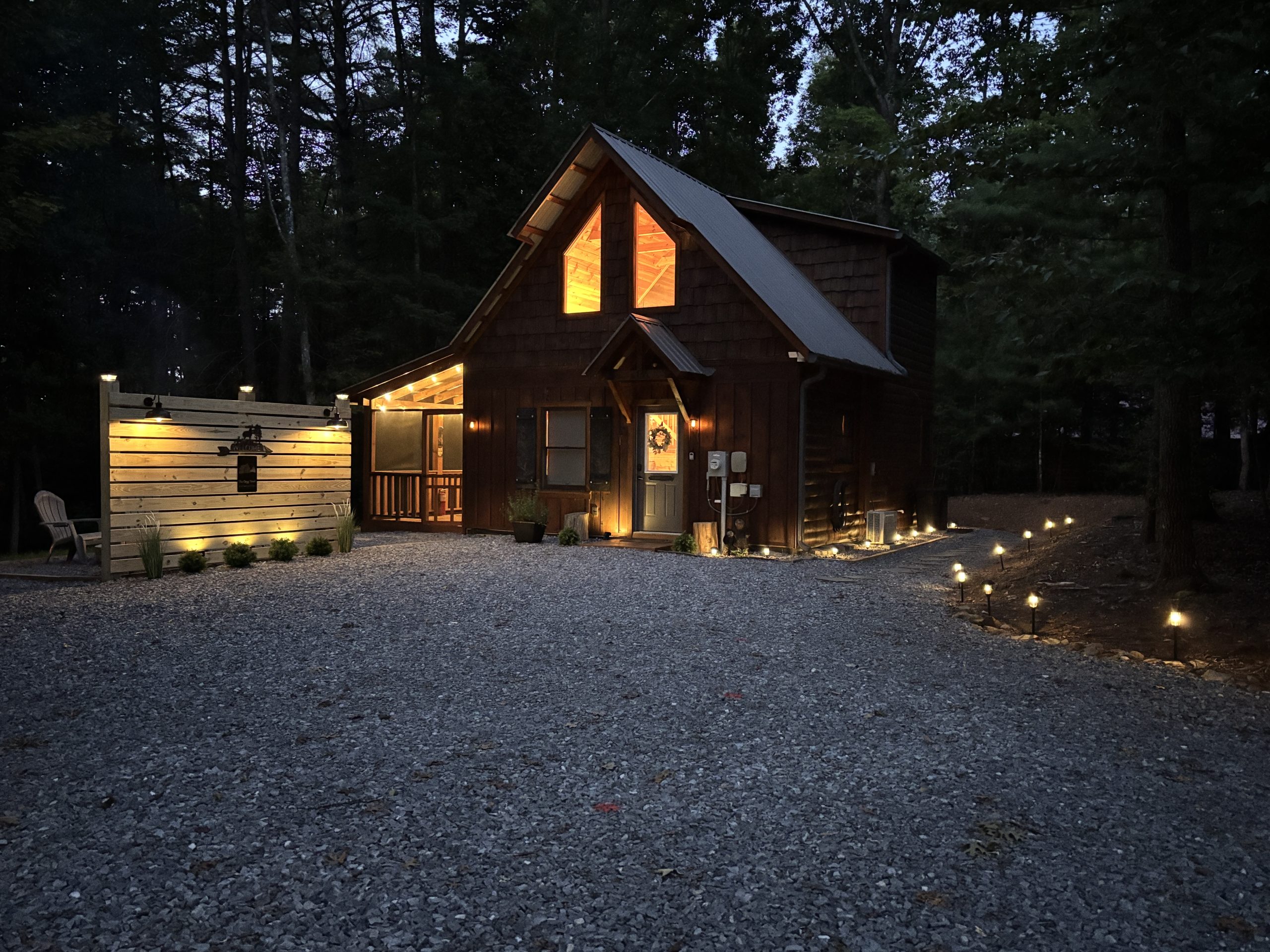The Cozy Nook cabin warmly illuminated at dusk in Murphy, North Carolina